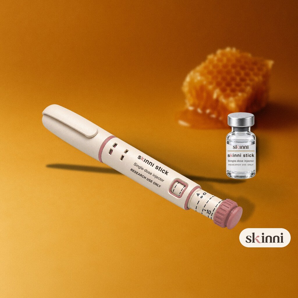 A clear CJC-1295 + Ipamorelin research vial on a coloured plaster ledge, with botanicals beside it