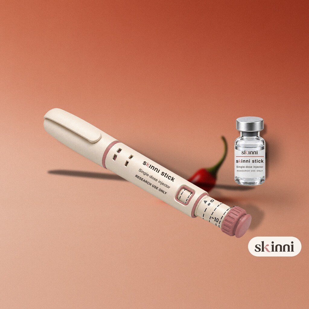 A clear Semaglutide research vial on a coloured plaster ledge, with botanicals beside it