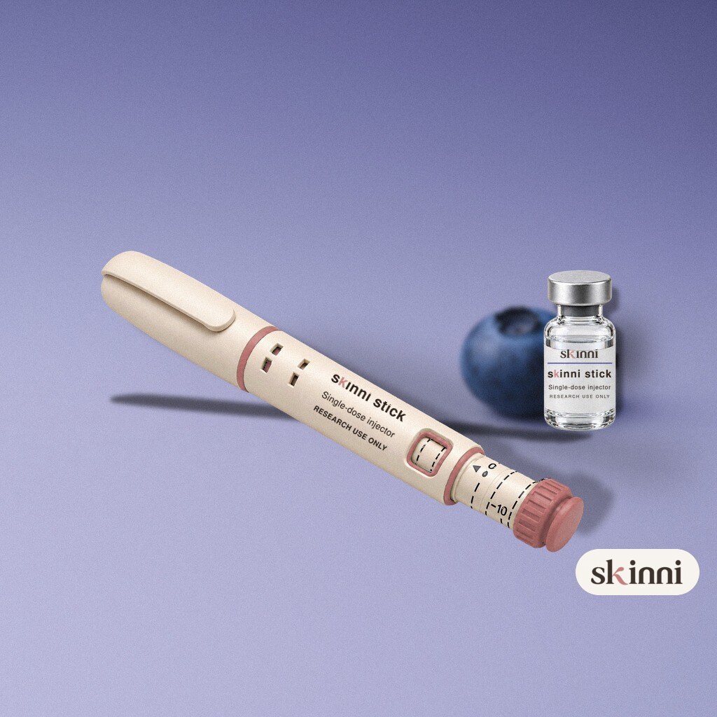 A clear Semax research vial on a coloured plaster ledge, with botanicals beside it