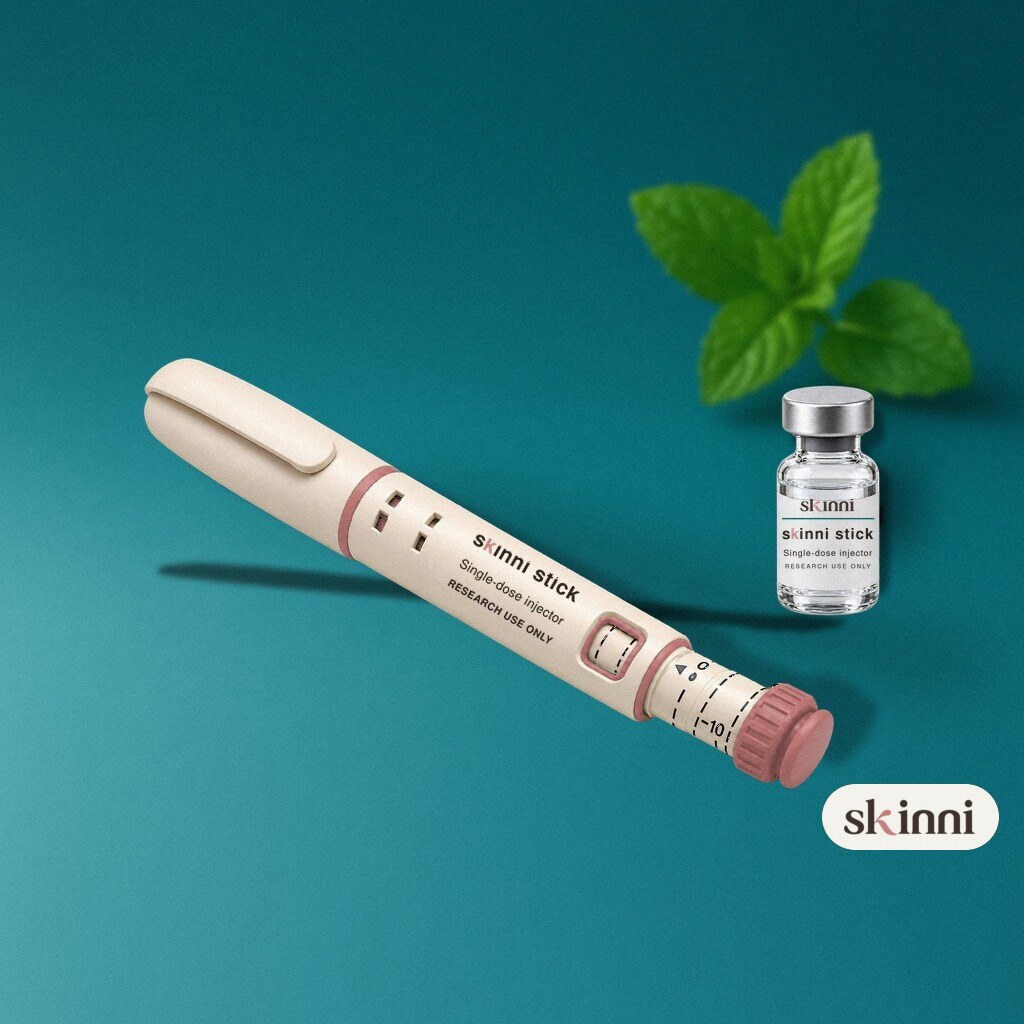 A clear Thymosin Alpha-1 research vial on a coloured plaster ledge, with botanicals beside it